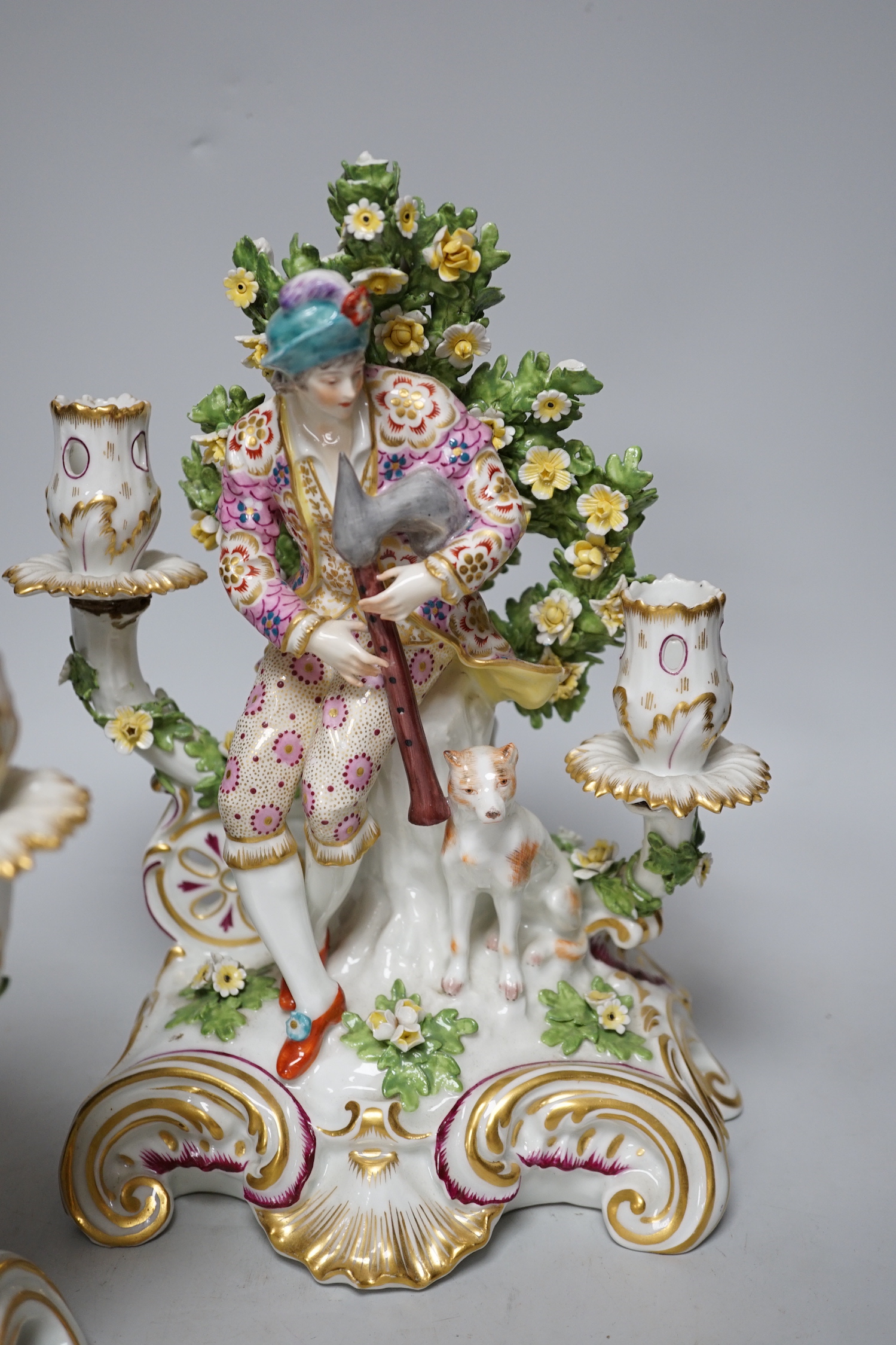 A pair of French porcelain two branch figural candlesticks in the form of musicians, largest 29cm high